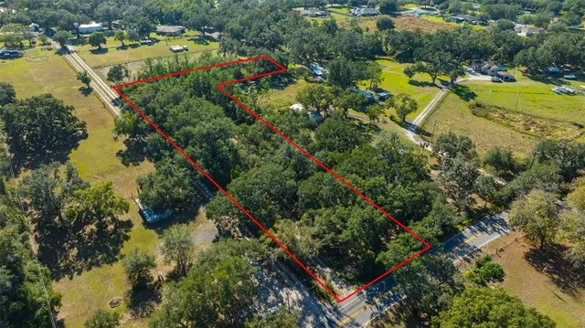 an aerial view of a houses with a lake view