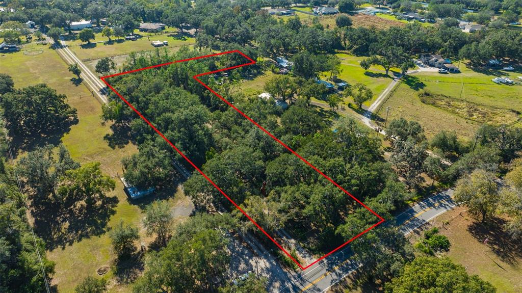 9580 McIntosh Road Dover, FL 33527 - Photo 2 of 15 an aerial view of a houses with a lake view