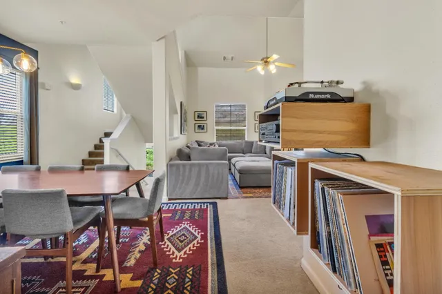 a living room with furniture a large window and a fireplace