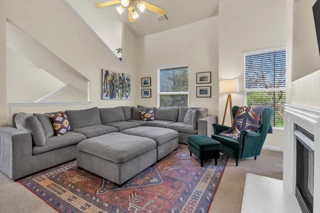 a living room with furniture and a lamp