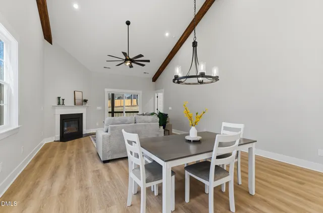 a view of a dining room with furniture wooden floor and chandelier