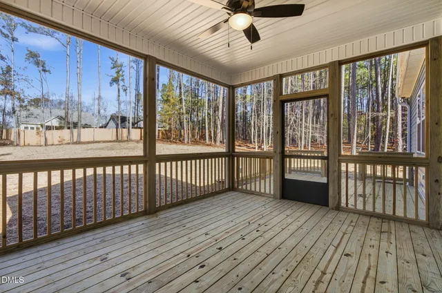 a view of a porch with wooden floor and iron stairs