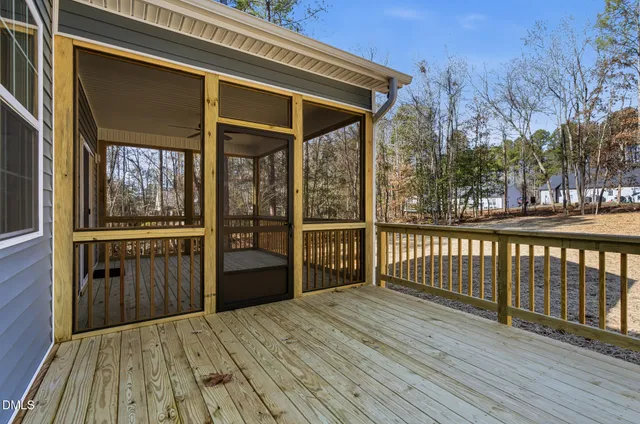 a view of a house with a wooden deck