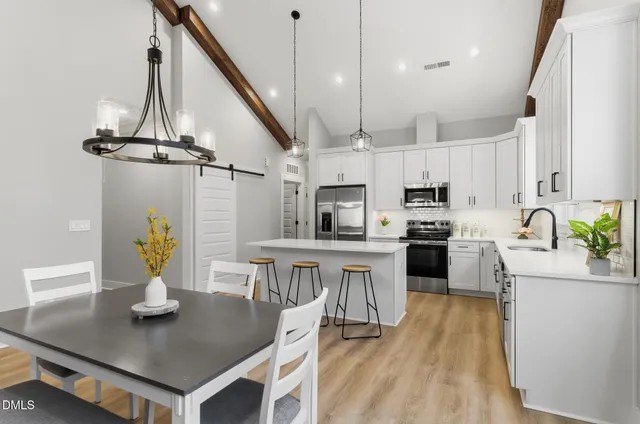 a kitchen with stainless steel appliances granite countertop a sink a stove and center island