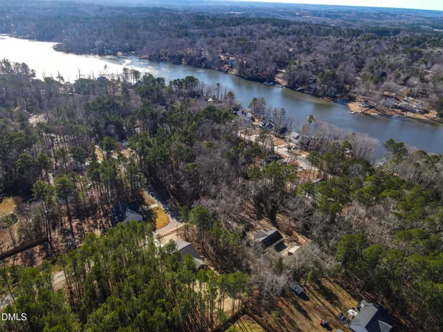 an aerial view of residential house with outdoor space and trees around