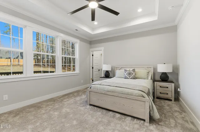 a bedroom with bed and a large window