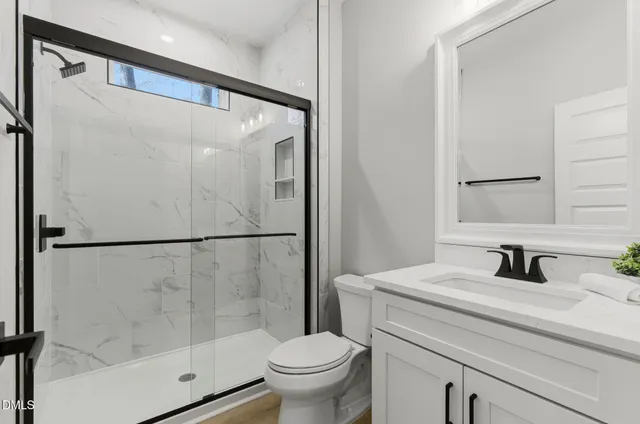 a bathroom with a sink toilet and shower
