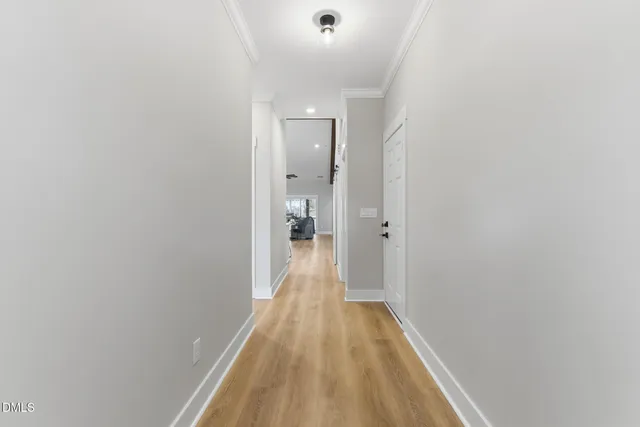 a view of a hallway with wooden floor