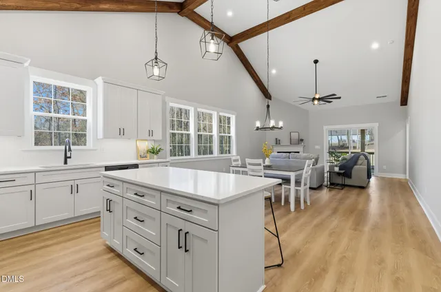 a kitchen with sink stove and cabinets