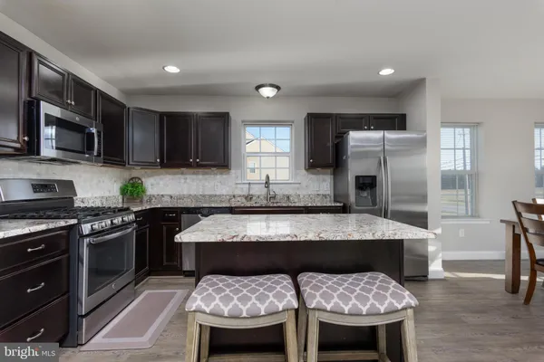 a kitchen with a stove a sink and a refrigerator