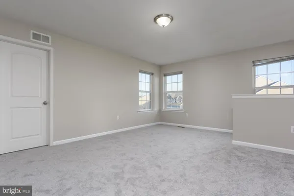 an empty room with closet and a window