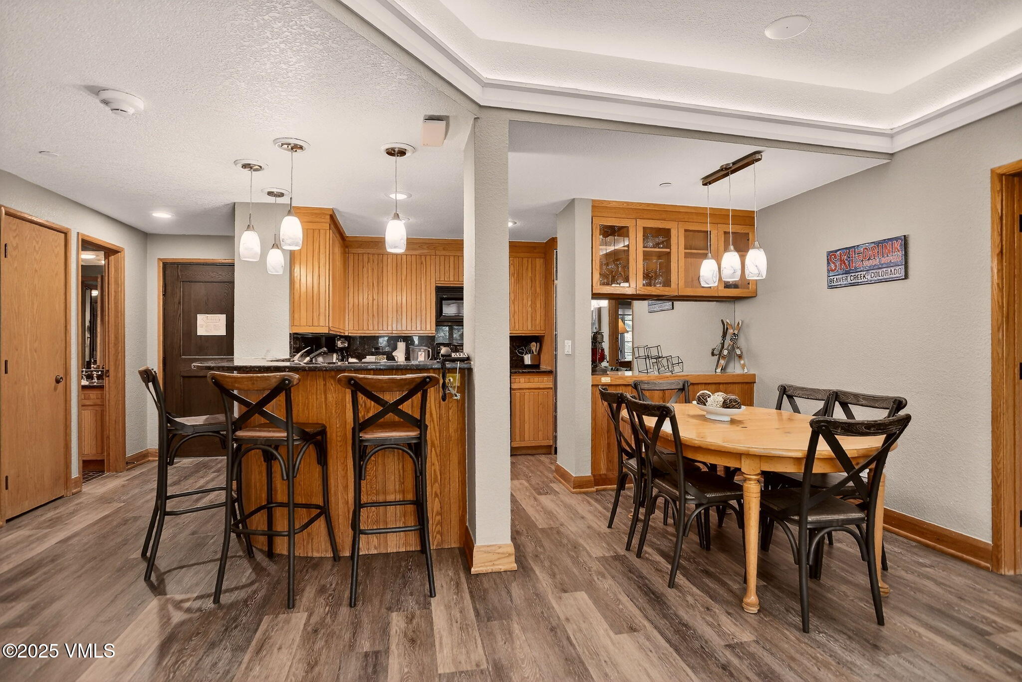 120 Offerson Road, Unit 5160 Beaver Creek, CO 81620 - Photo 4 of 30 a view of a dining room with furniture and wooden floor