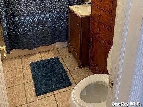 721 Meadow Road Smithtown, NY 11787 - Photo 3 of 10 a bathroom with a toilet and a sink