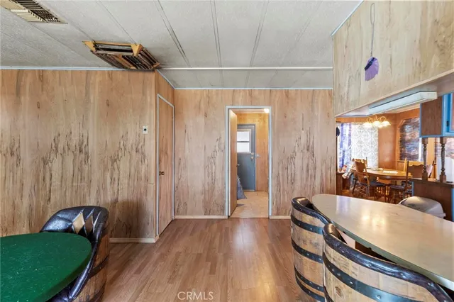 a kitchen with stainless steel appliances a stove a refrigerator a dining table and chairs