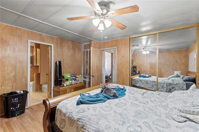 a bedroom with a bed and flat screen tv