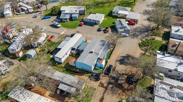 an aerial view of residential houses with outdoor space