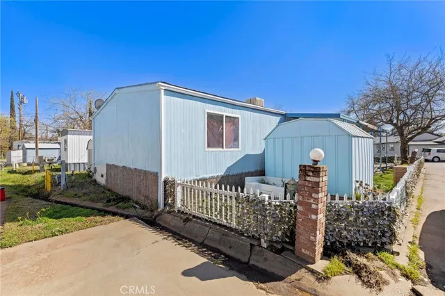 a view of a house with a wooden fence