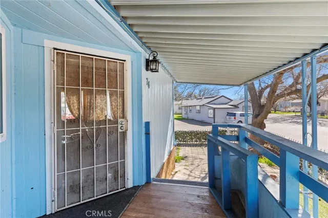 a view of a house with a window and wooden fence