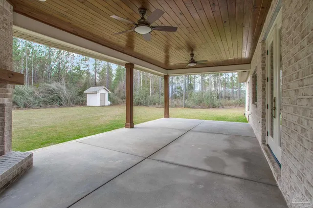 a open kitchen with stainless steel appliances granite countertop a stove a sink a oven a dining table and chairs with wooden floor