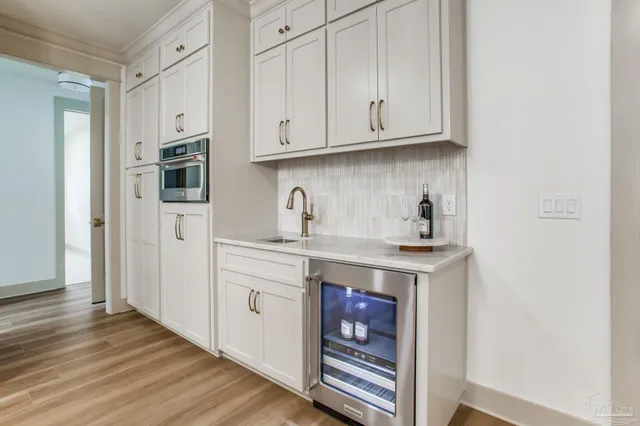 a kitchen with stainless steel appliances granite countertop a sink a stove a refrigerator and cabinets