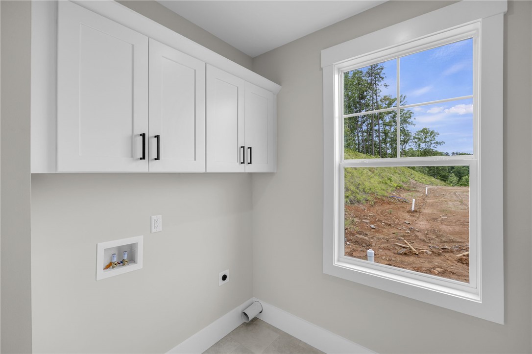 1230 Melton Road, Unit 216 West Union, SC 29696 - Photo 16 of 49 Ample storage solutions elevate this functional and naturally illuminated laundry area.