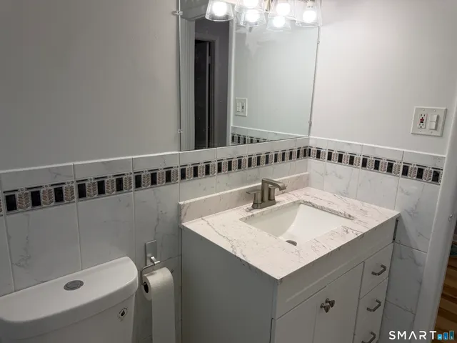 a large kitchen with stainless steel appliances granite countertop a lot of counter space and wooden floors