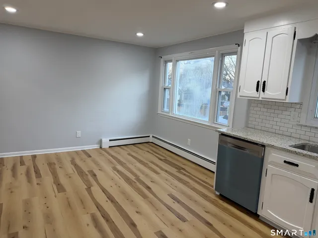 a view of a porch with wooden floor and fence