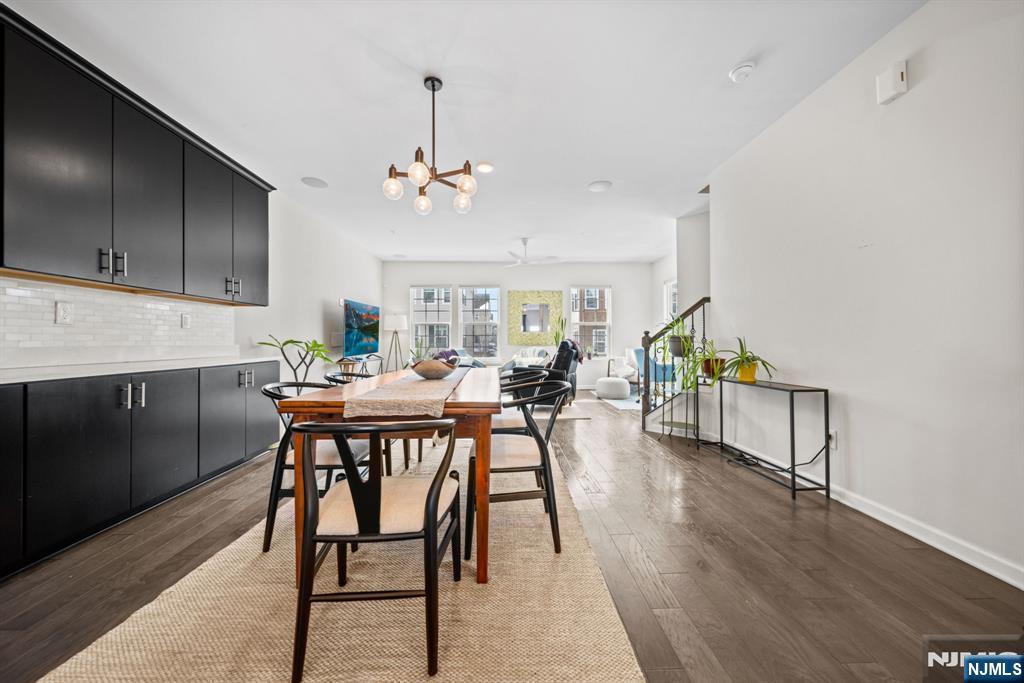 84 Truman Drive, Unit 2801 Wood-Ridge, NJ 07075 - Photo 12 of 46 a view of a dining room with furniture and wooden floor