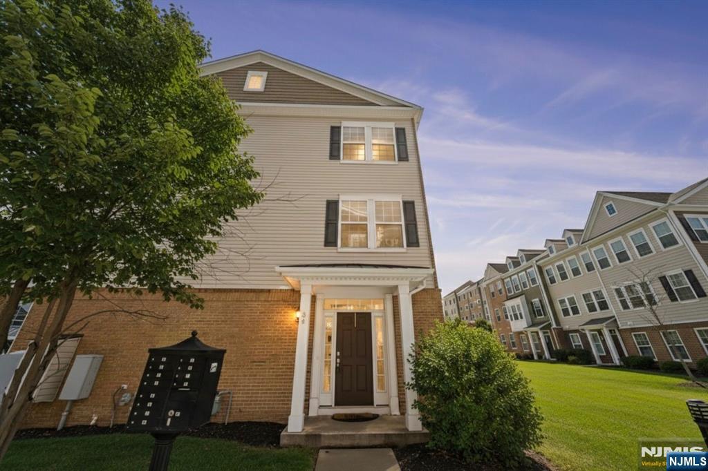 84 Truman Drive, Unit 2801 Wood-Ridge, NJ 07075 - Photo 2 of 46 front view of a house with a yard