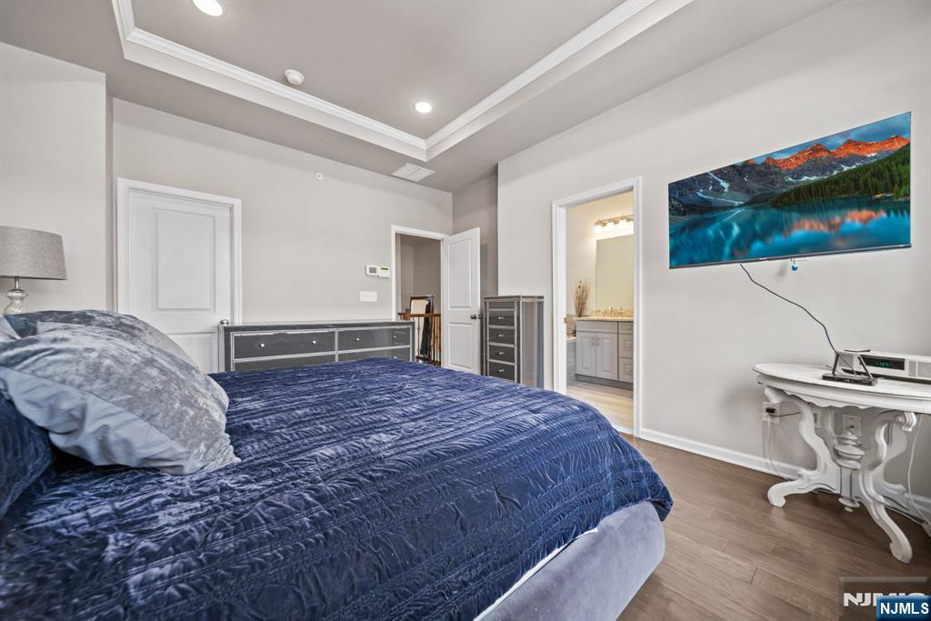 84 Truman Drive, Unit 2801 Wood-Ridge, NJ 07075 - Photo 24 of 46 a spacious bedroom with a bed and a flat screen tv