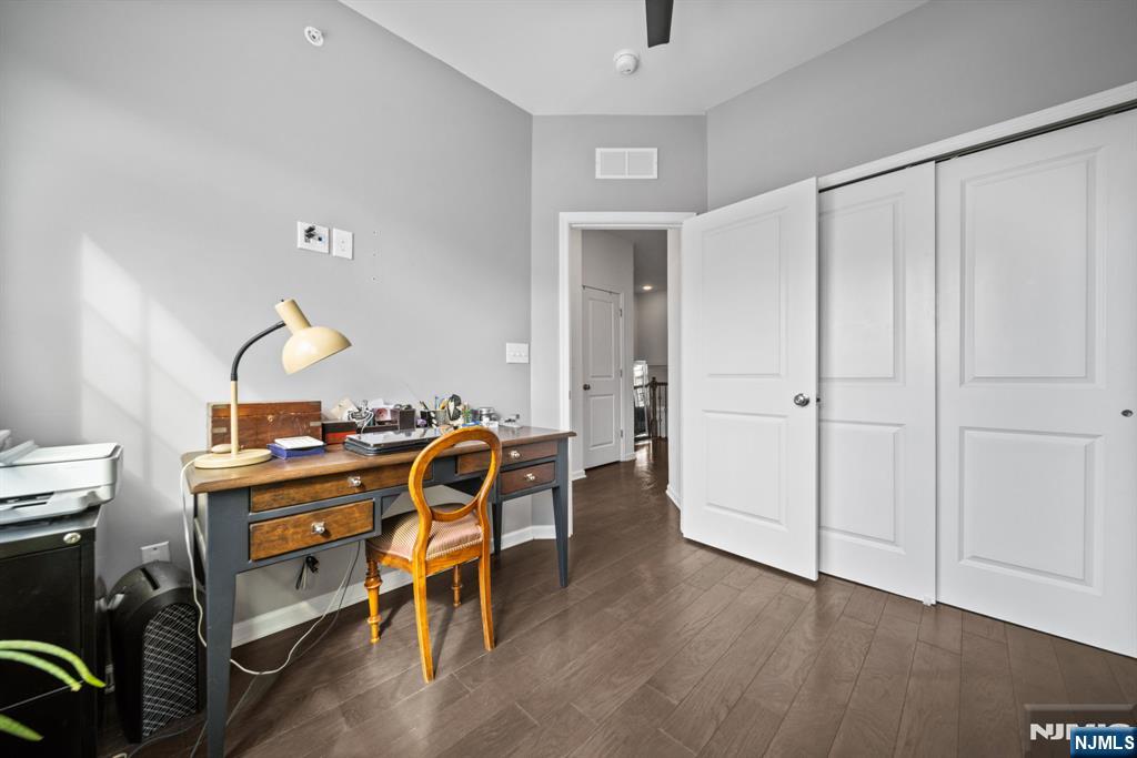 84 Truman Drive, Unit 2801 Wood-Ridge, NJ 07075 - Photo 29 of 46 a view of a workspace with furniture and wooden floor