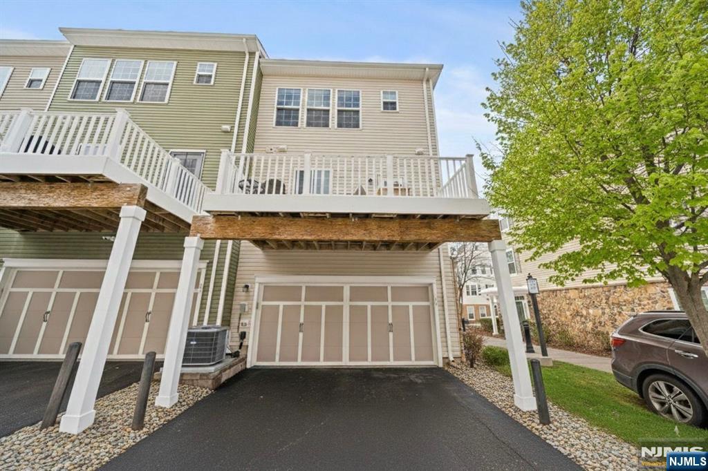 84 Truman Drive, Unit 2801 Wood-Ridge, NJ 07075 - Photo 33 of 46 a front view of a house with a yard