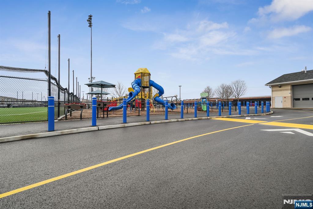 84 Truman Drive, Unit 2801 Wood-Ridge, NJ 07075 - Photo 34 of 46 a childrens park with lots of swings and slides