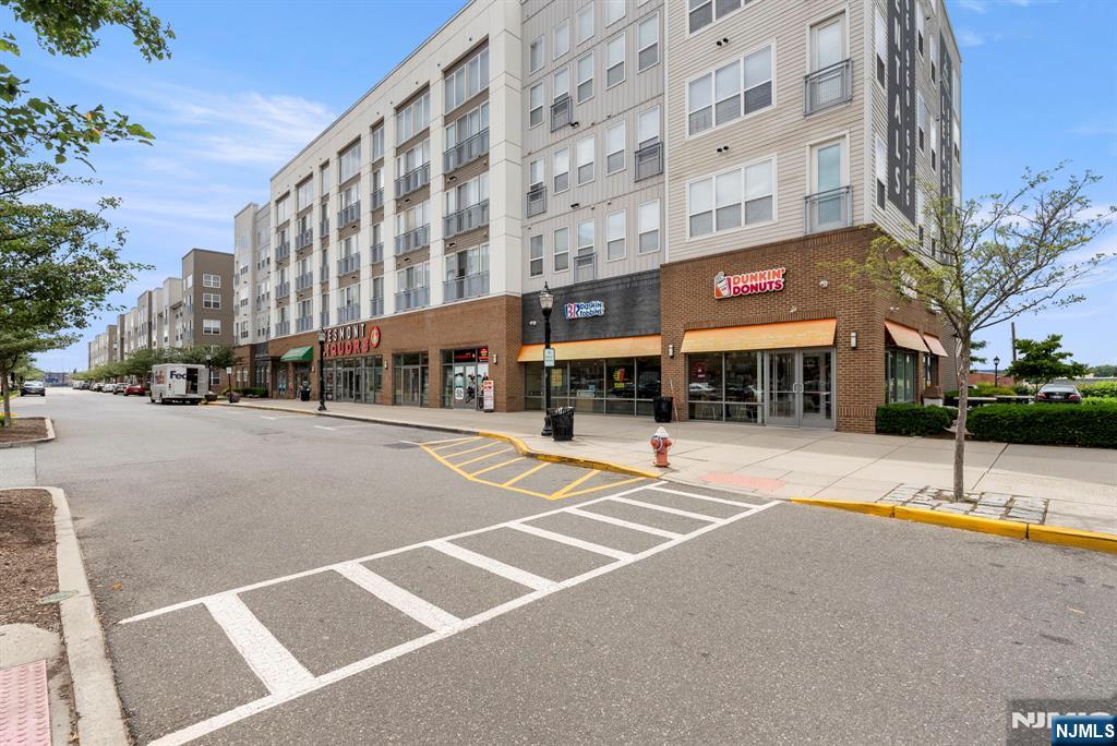 84 Truman Drive, Unit 2801 Wood-Ridge, NJ 07075 - Photo 38 of 46 a city street lined with buildings and trees