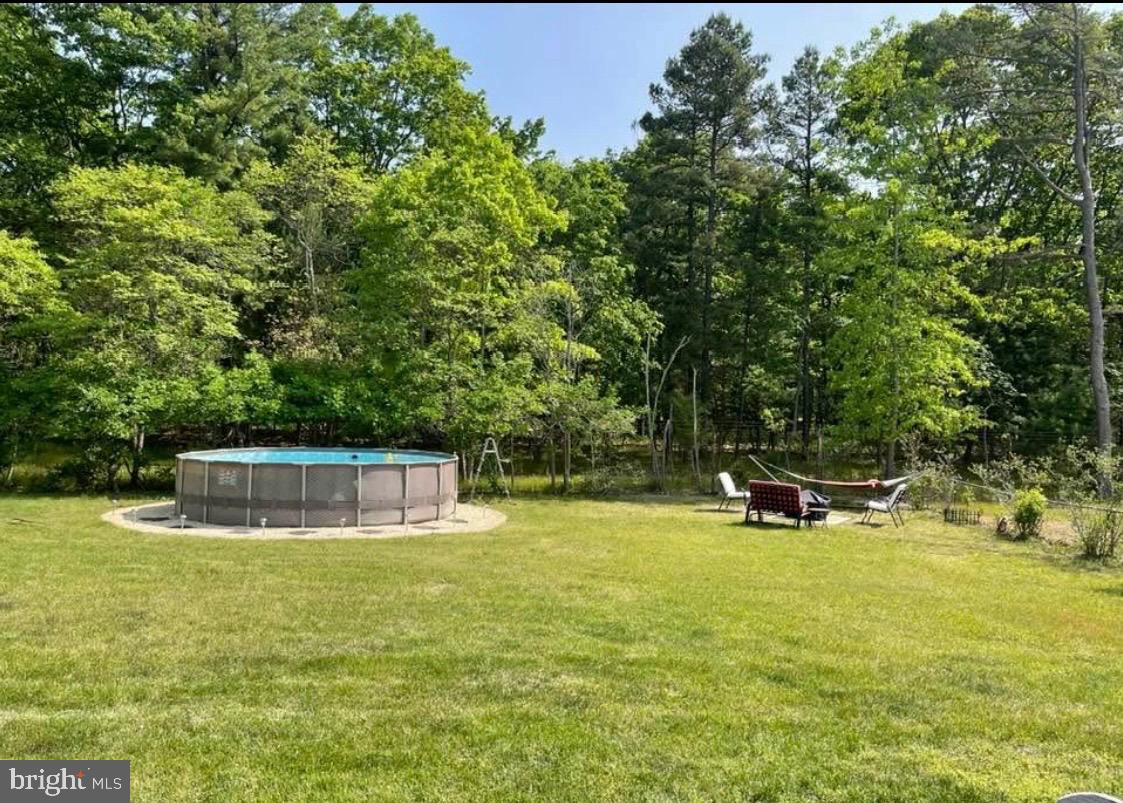 146 Country Club Road Pine Hill, NJ 08021 - Photo 27 of 28 a swimming pool with trees in the background
