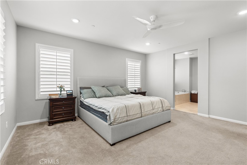 20948 Center Street Riverside, CA 92507 - Photo 51 of 92 a spacious bedroom with a bed and a ceiling fan
