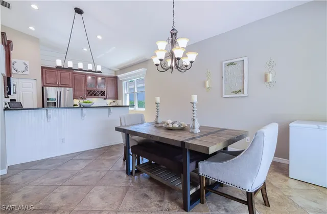 a view of a dining room with furniture a chandelier and wooden floor