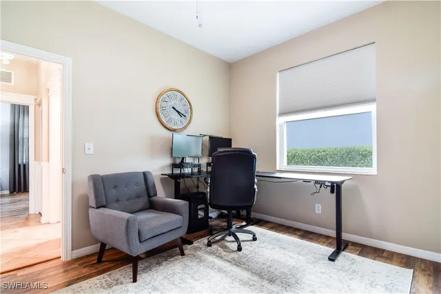 a view of workspace with wooden floor windows
