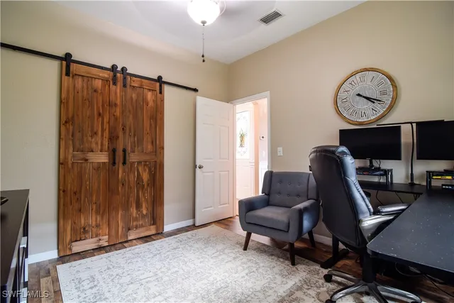 a view of a livingroom with workspace and a window