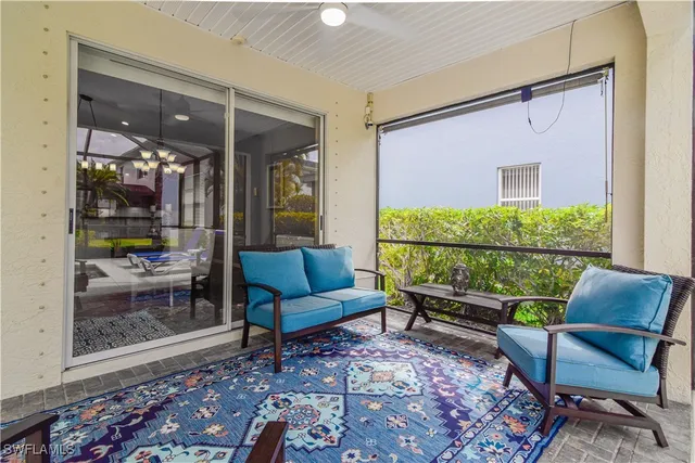 a living room with furniture and a floor to ceiling window