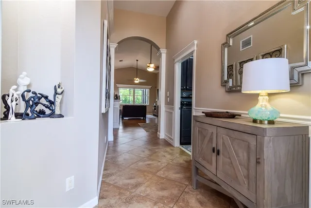 a view of a hallway to a livingroom and a couch