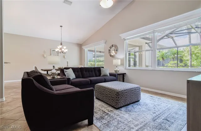 a living room with furniture chandelier and a window