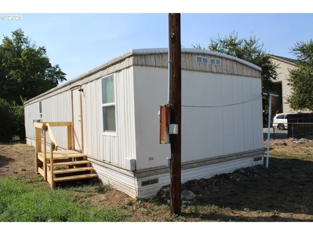 a backyard of a house with wooden floor and fence