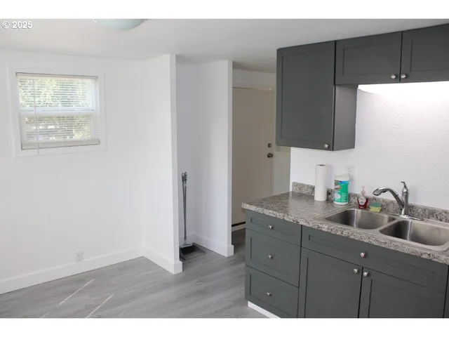 a kitchen with a sink and a mirror
