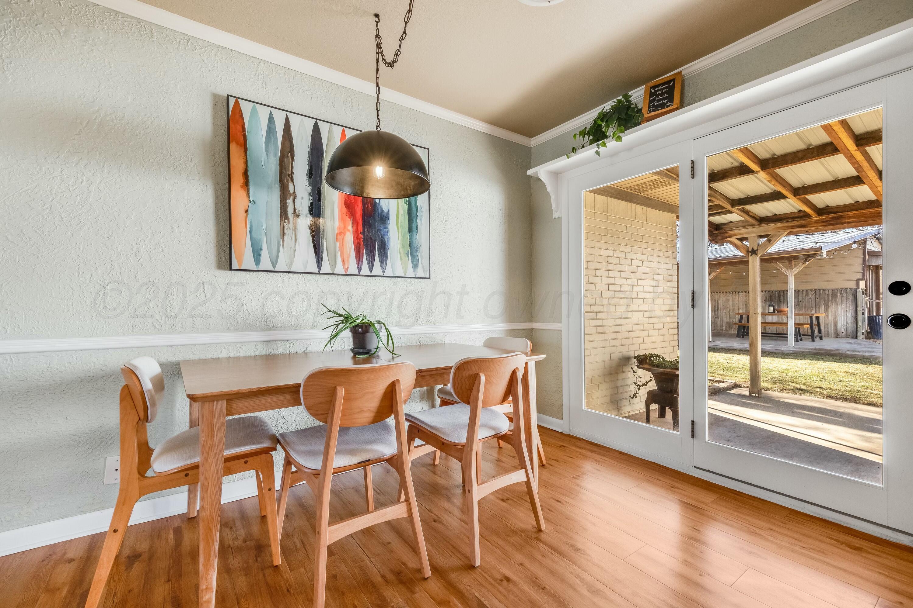 3128 Nebraska Street Amarillo, TX 79106 - Photo 15 of 34 a view of a dining room with furniture wooden floor and chandelier