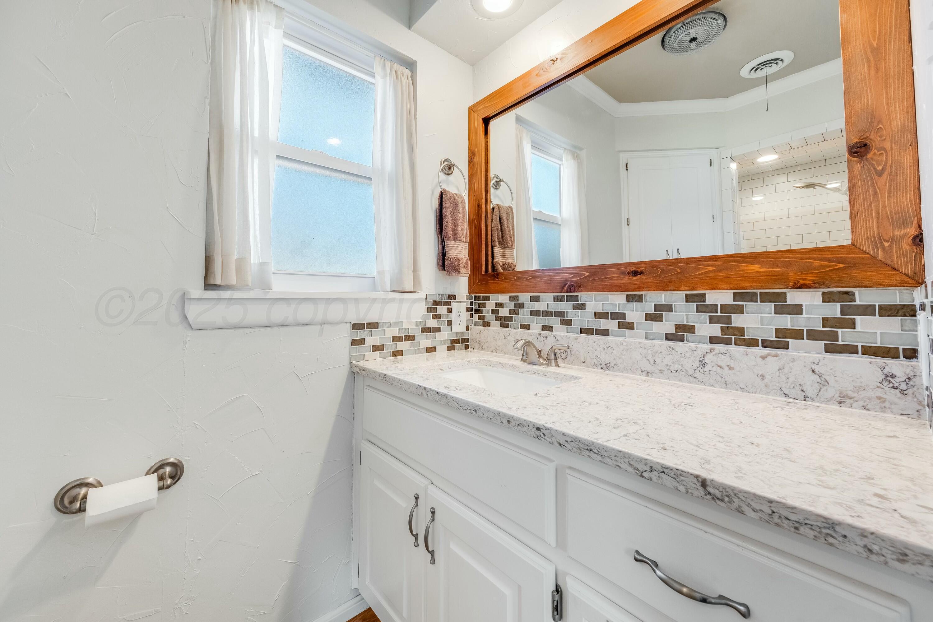 3128 Nebraska Street Amarillo, TX 79106 - Photo 18 of 34 a bathroom with a sink and a mirror