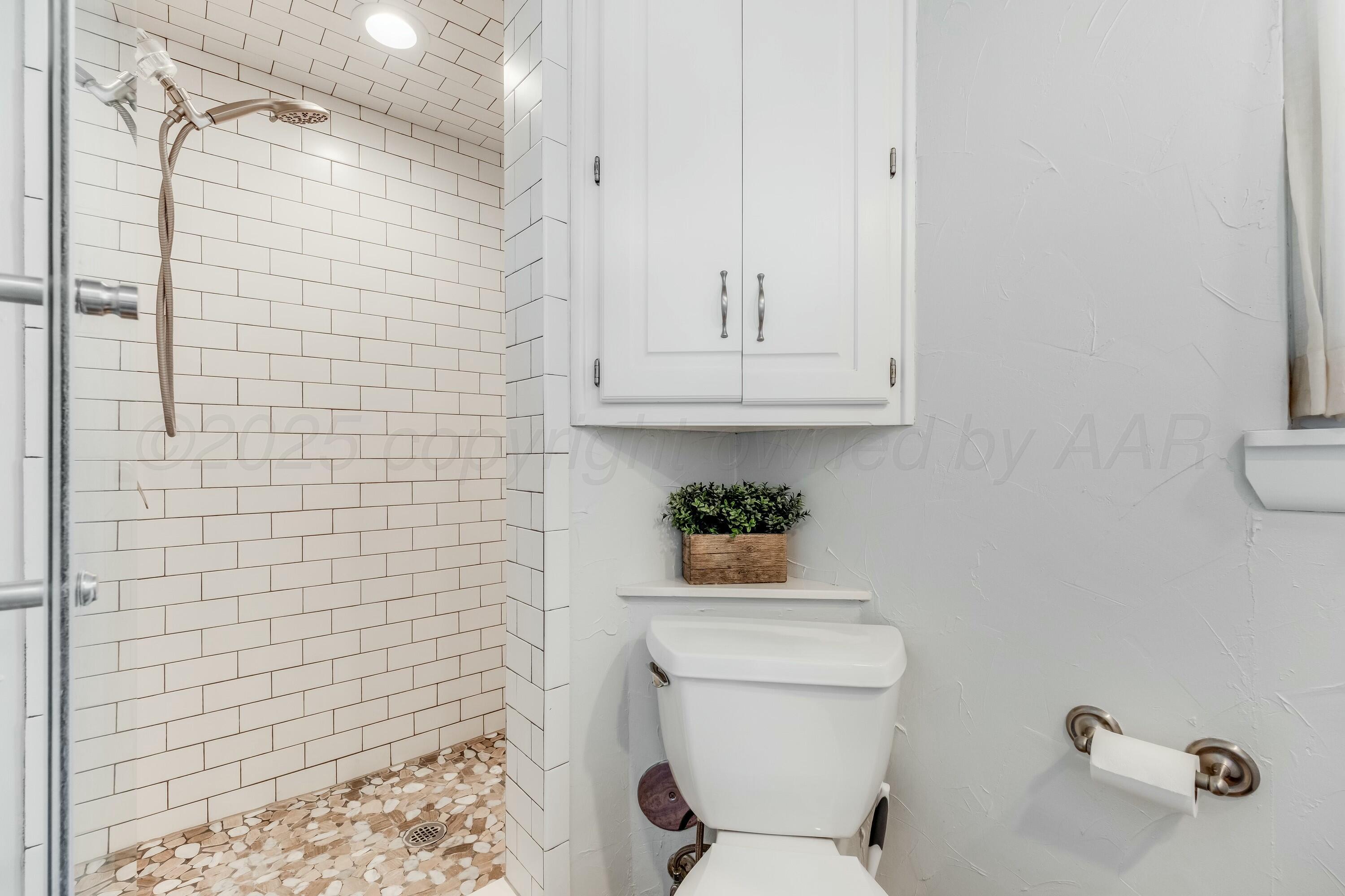 3128 Nebraska Street Amarillo, TX 79106 - Photo 19 of 34 a bathroom with a toilet and a shower
