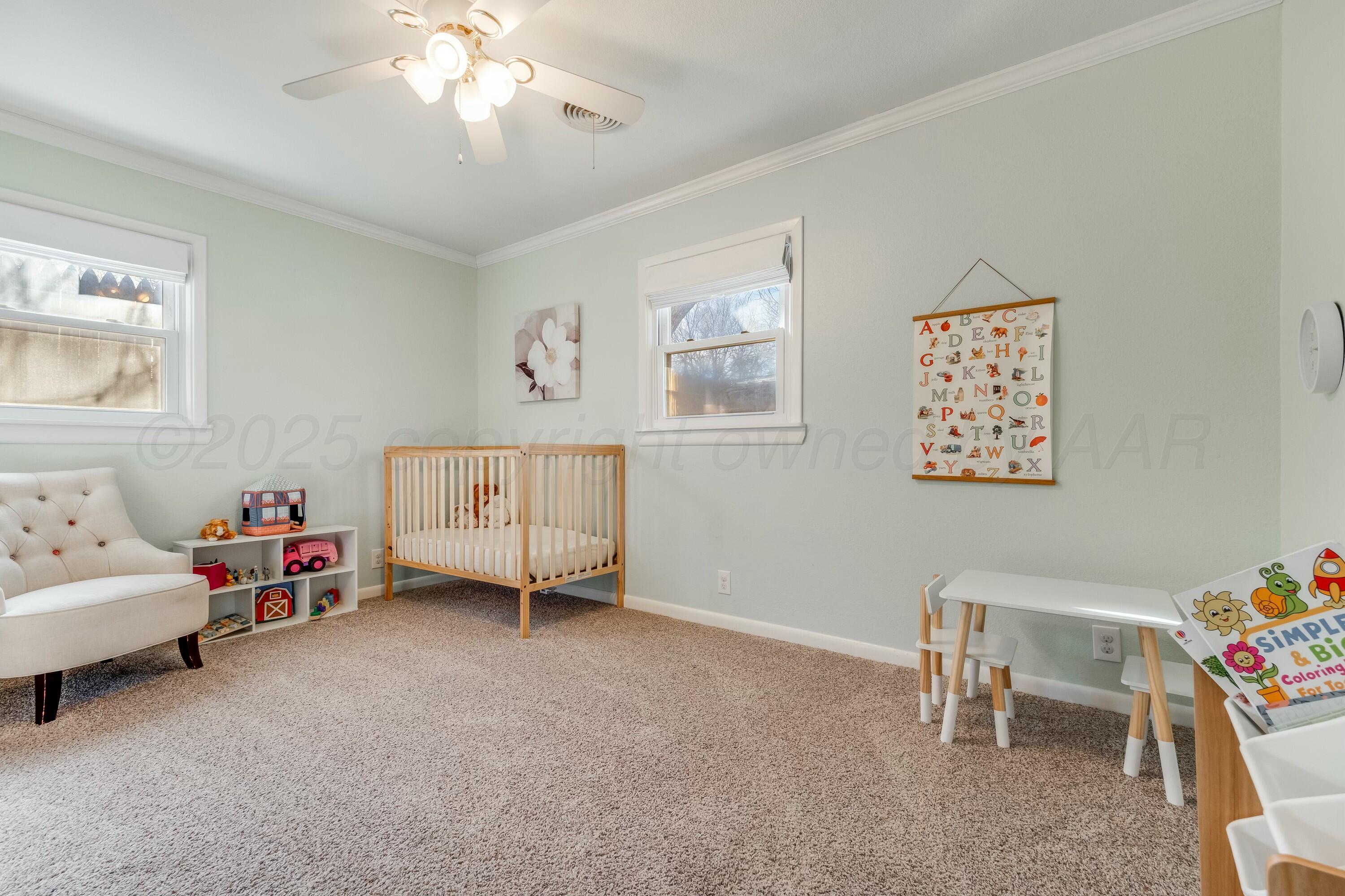 3128 Nebraska Street Amarillo, TX 79106 - Photo 21 of 34 a living room with furniture and a baby crib