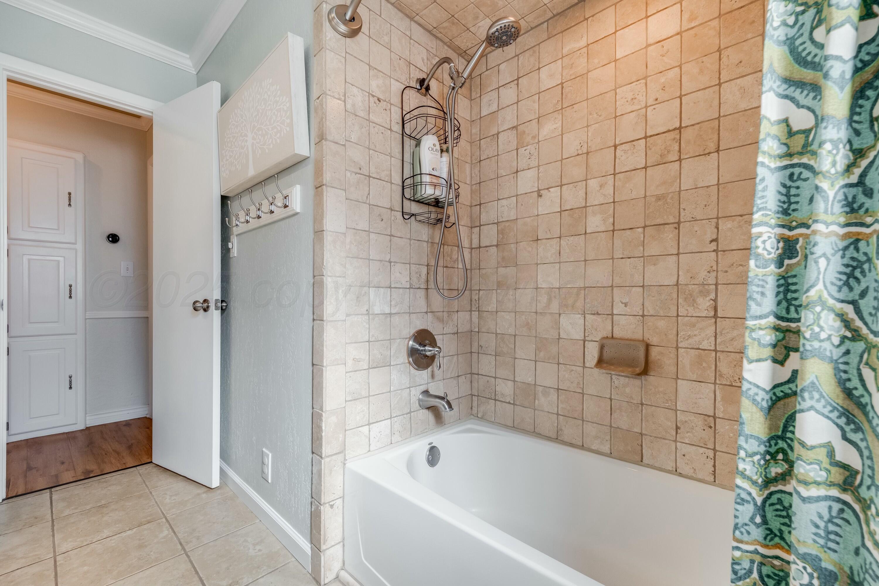 3128 Nebraska Street Amarillo, TX 79106 - Photo 23 of 34 a bathroom with a bathtub and shower