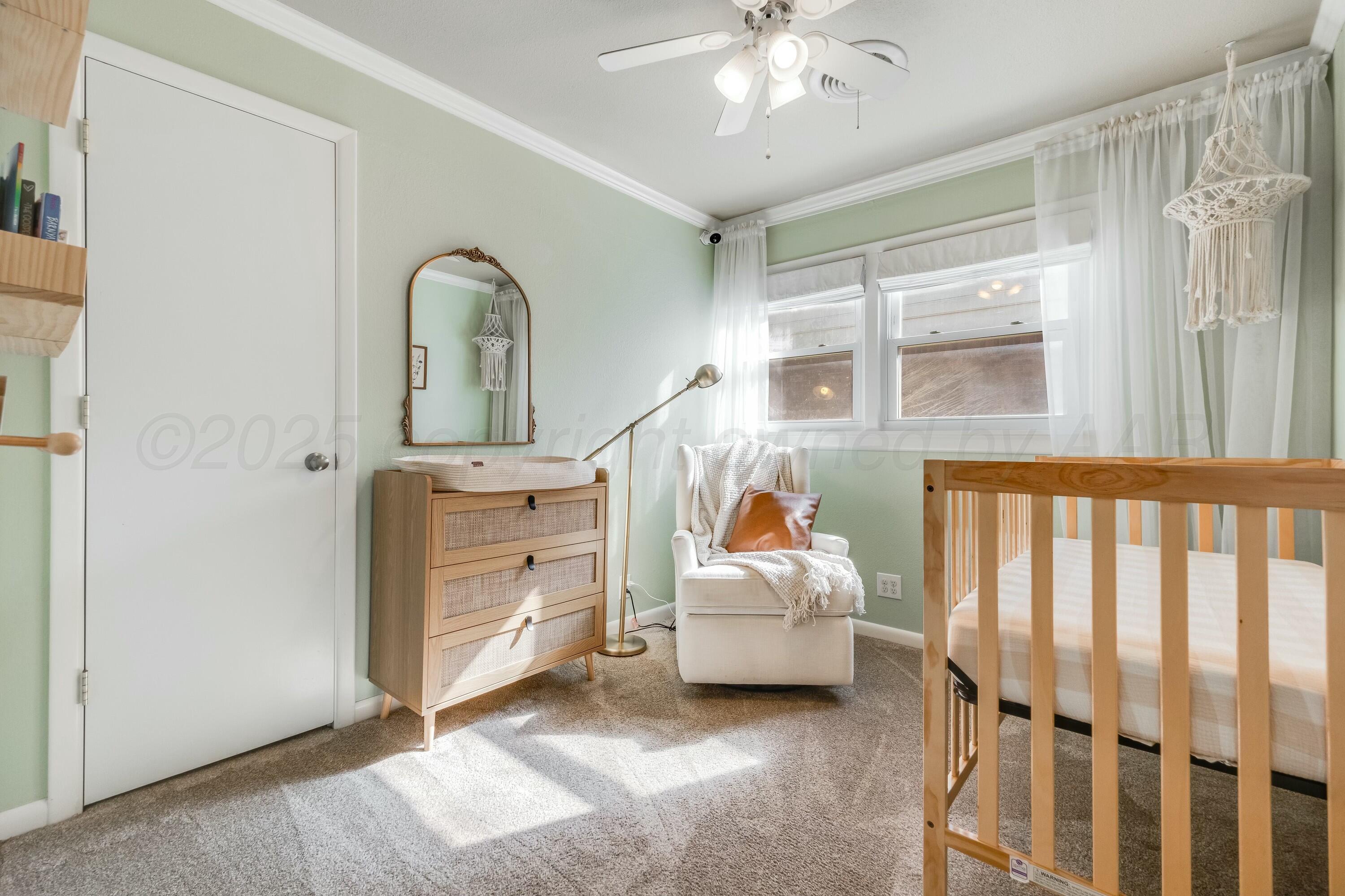 3128 Nebraska Street Amarillo, TX 79106 - Photo 24 of 34 a bedroom with a bed and a chandelier